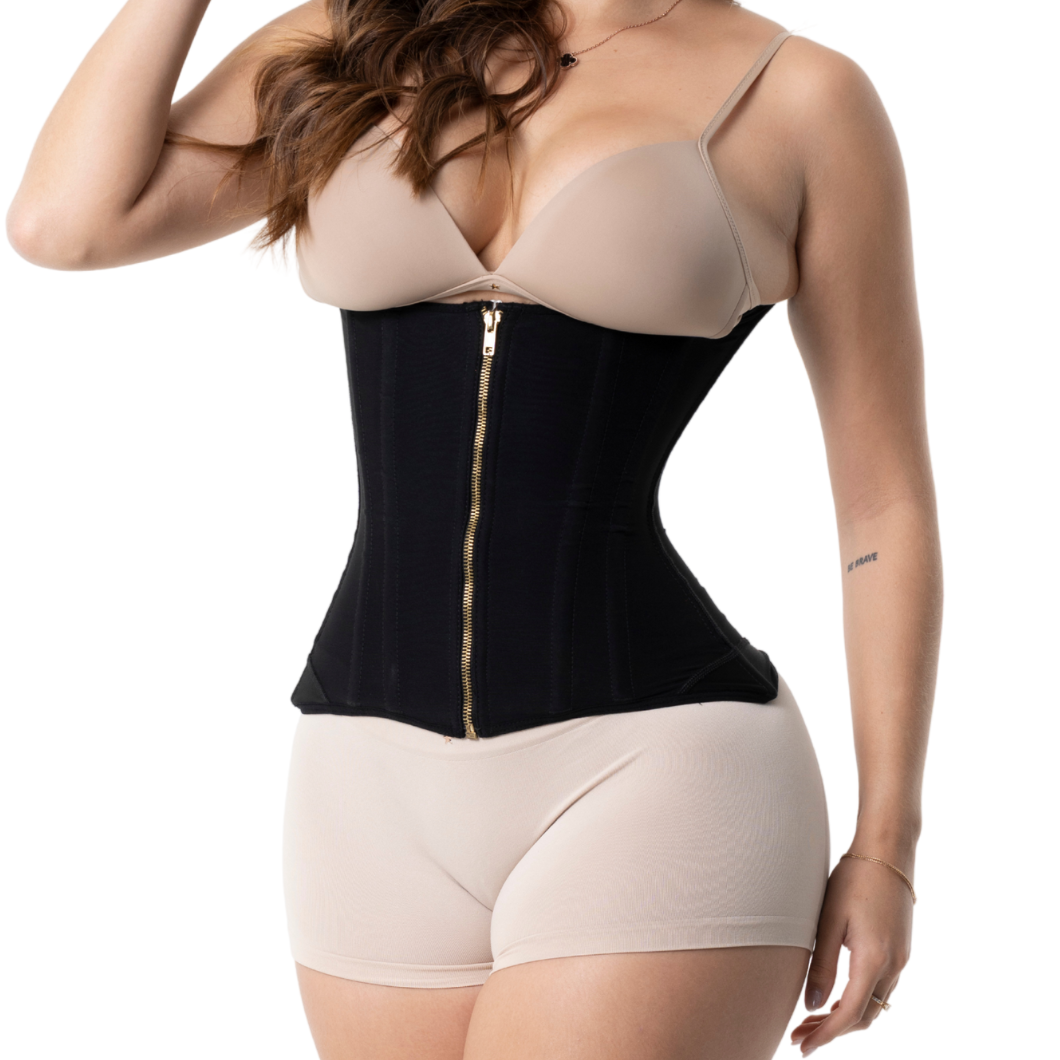 Woman wearing a black and beige waist trainer on a white background
