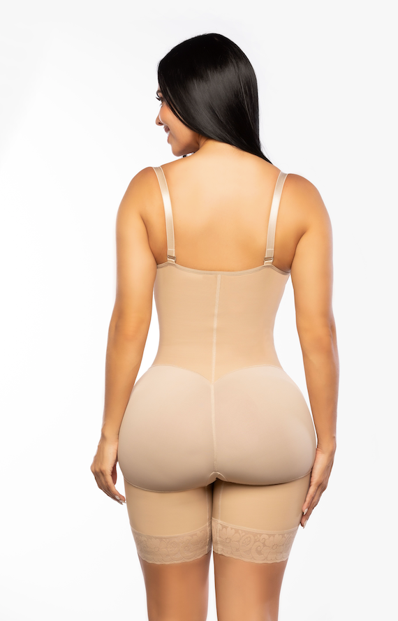 Woman wearing a beige shapewear bodysuit on a white background