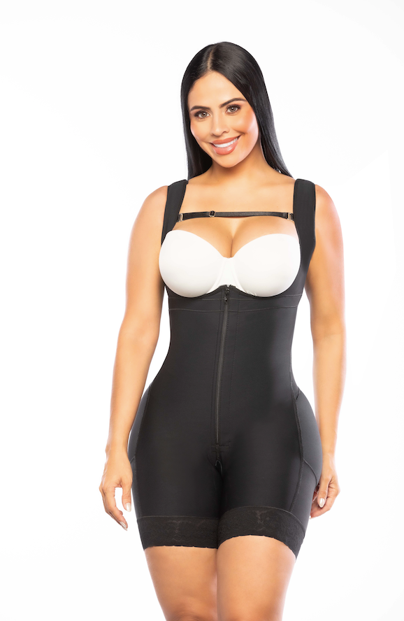 Woman wearing a black shapewear garment with a white bra on a white background