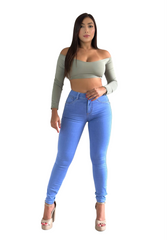Woman wearing a green crop top and blue jeans on a white background