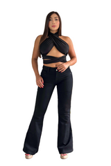 Woman wearing a black top and black jeans standing in a living room.