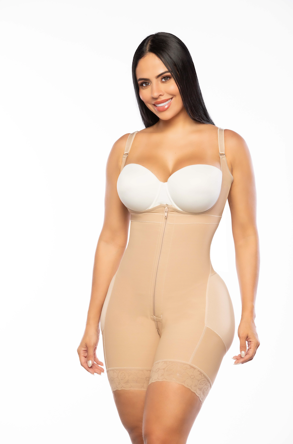 Woman wearing a beige shapewear garment with a white bra on a white background
