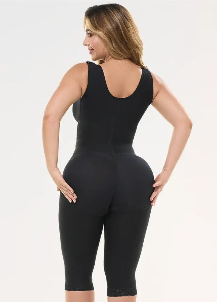 Woman wearing a black bodysuit against a white background