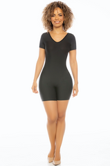 Woman wearing a black bodysuit on a white background