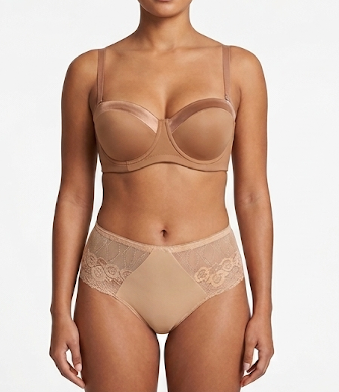 Woman wearing a beige bra and panties set on a white background