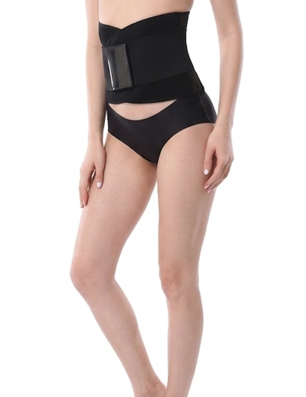 Person wearing a black waist trainer and high-waisted underwear on a white background