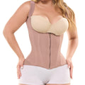 woman wearing a beige vest with hands on her hip