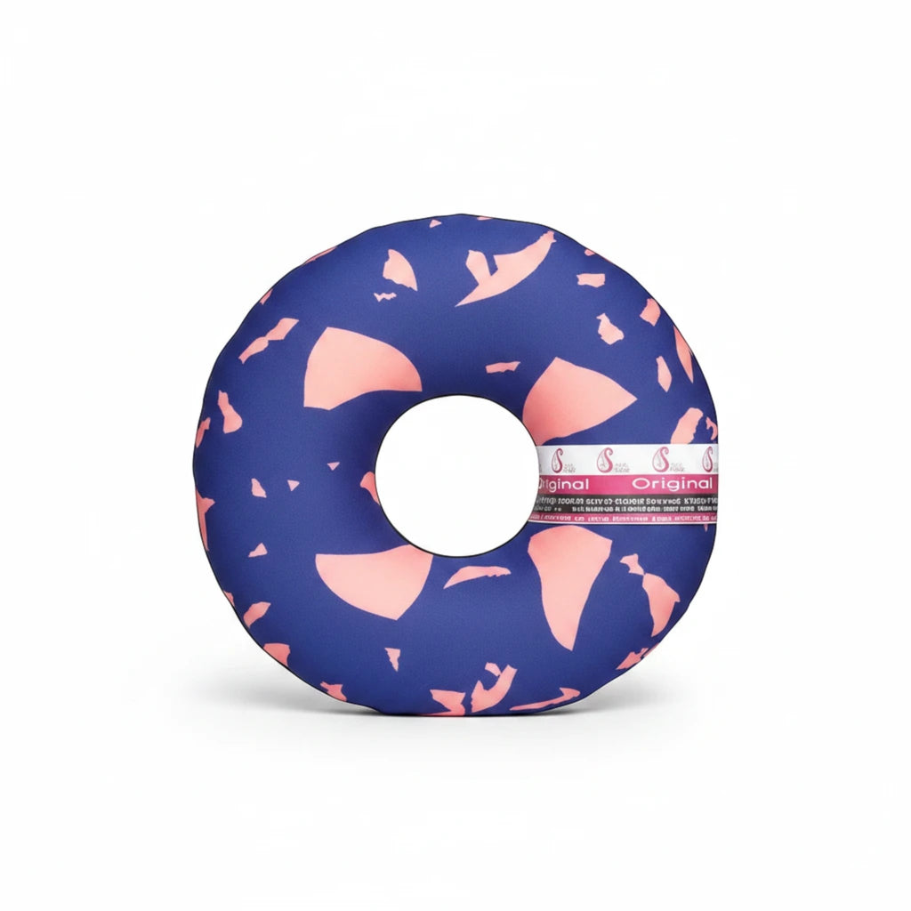 Stella's Corset BBL post-surgery coccyx cushion in blue with a pink terrazzo pattern for recovery support.