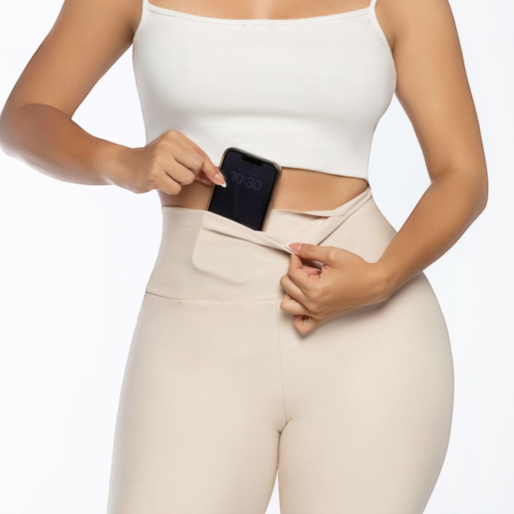 Stella's Corset beige athletic pants with a hidden phone pocket. High-waisted, flexible, and moisture-wicking.