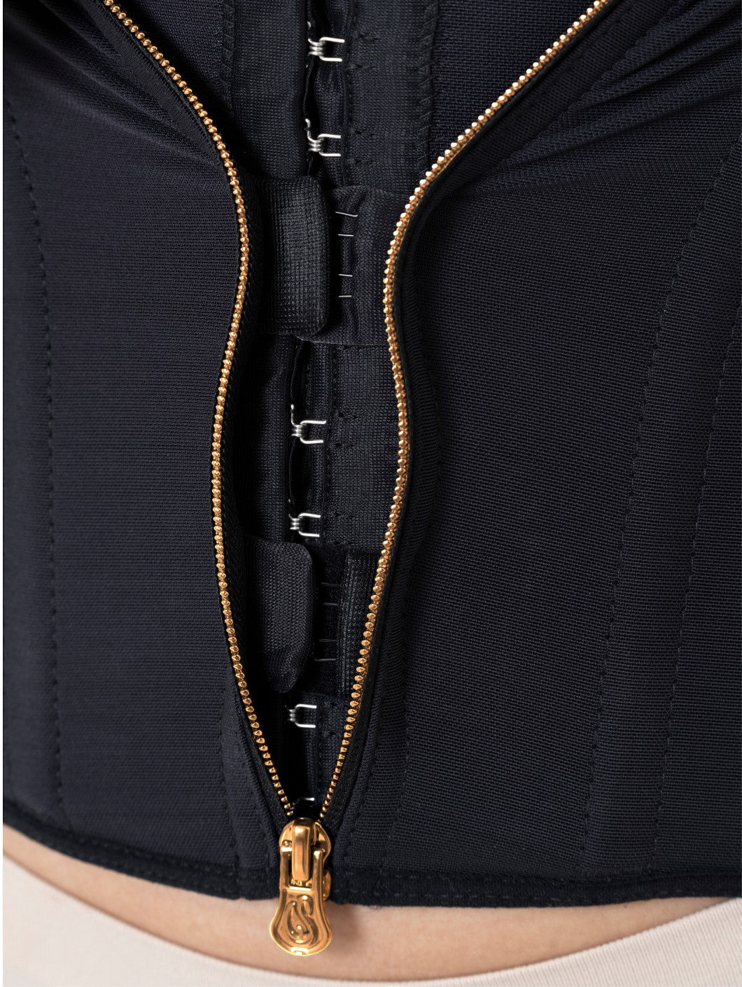 Stella's Corset black Powernet compression faja with gold zipper and hook-and-eye closure, high-back design.