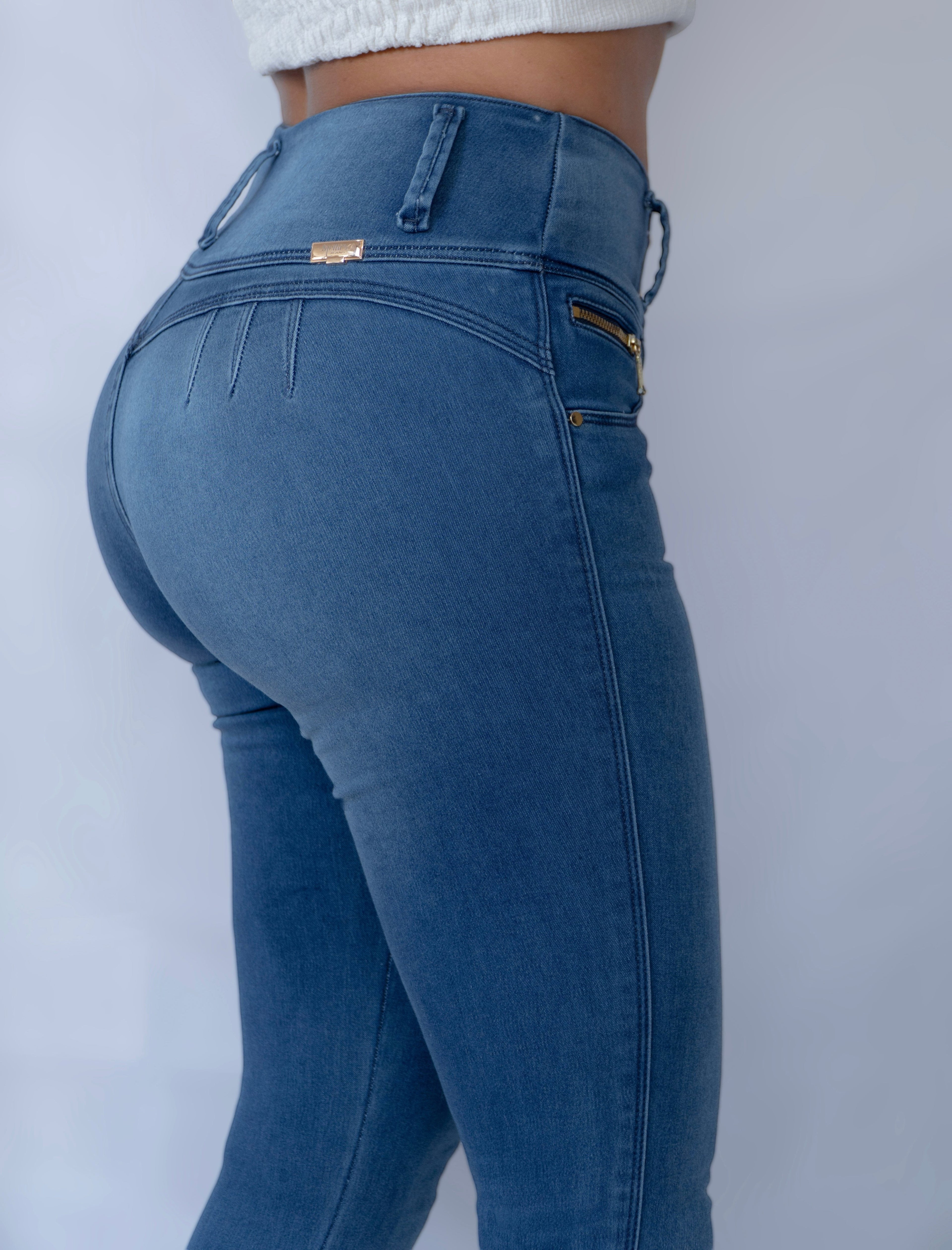 Stella's Corset blue denim butt lifter skinny jeans with front zipper accents and no back pockets.